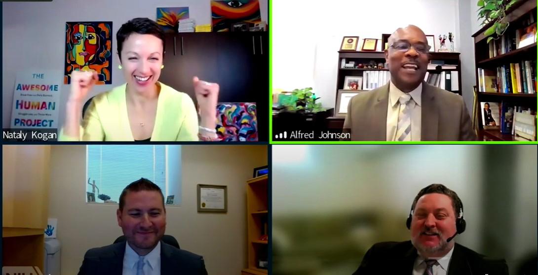 A screen shot shows Kogan smiling widely with fists in the air in victory, a smiling Dr. Johnson and two NIH executive officers listening to the exchange.
