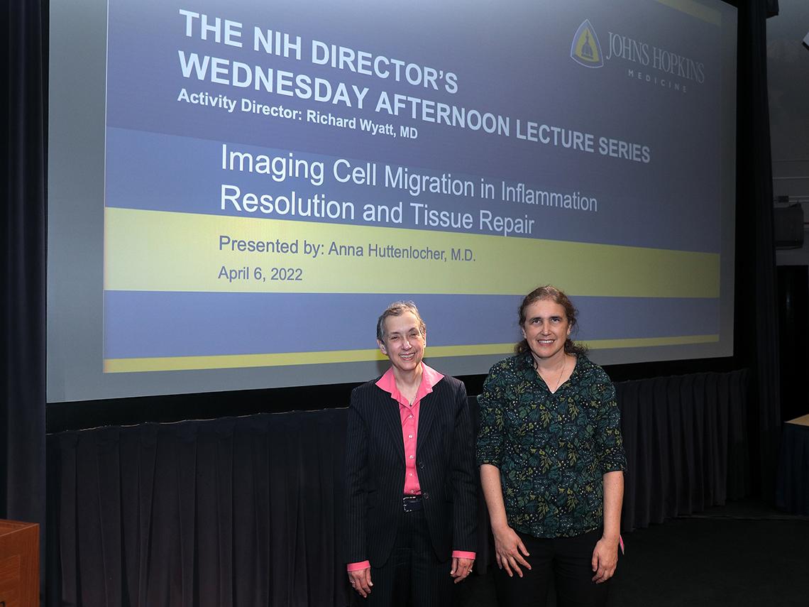 Schor and Huttenlocher stand in front of the lecture's title slide.