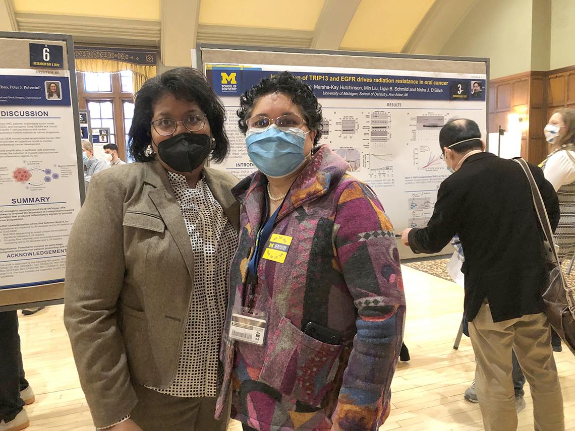 Webster-Cyriaque poses with an attendee at a poster day.