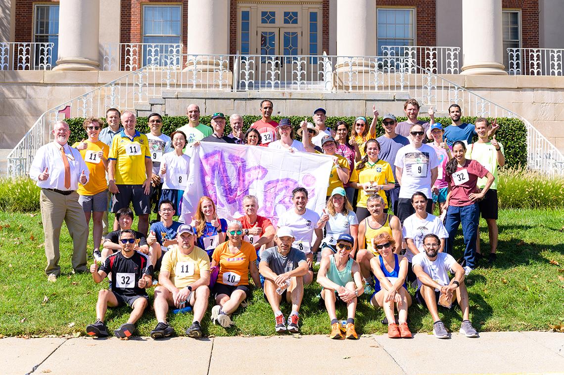Large group of runners and team supporters in front of Bldg. 1