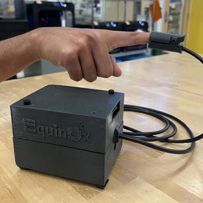 A person models a finger pulse oximeter