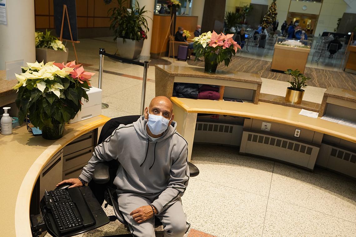 Alexander sits at the CC information desk