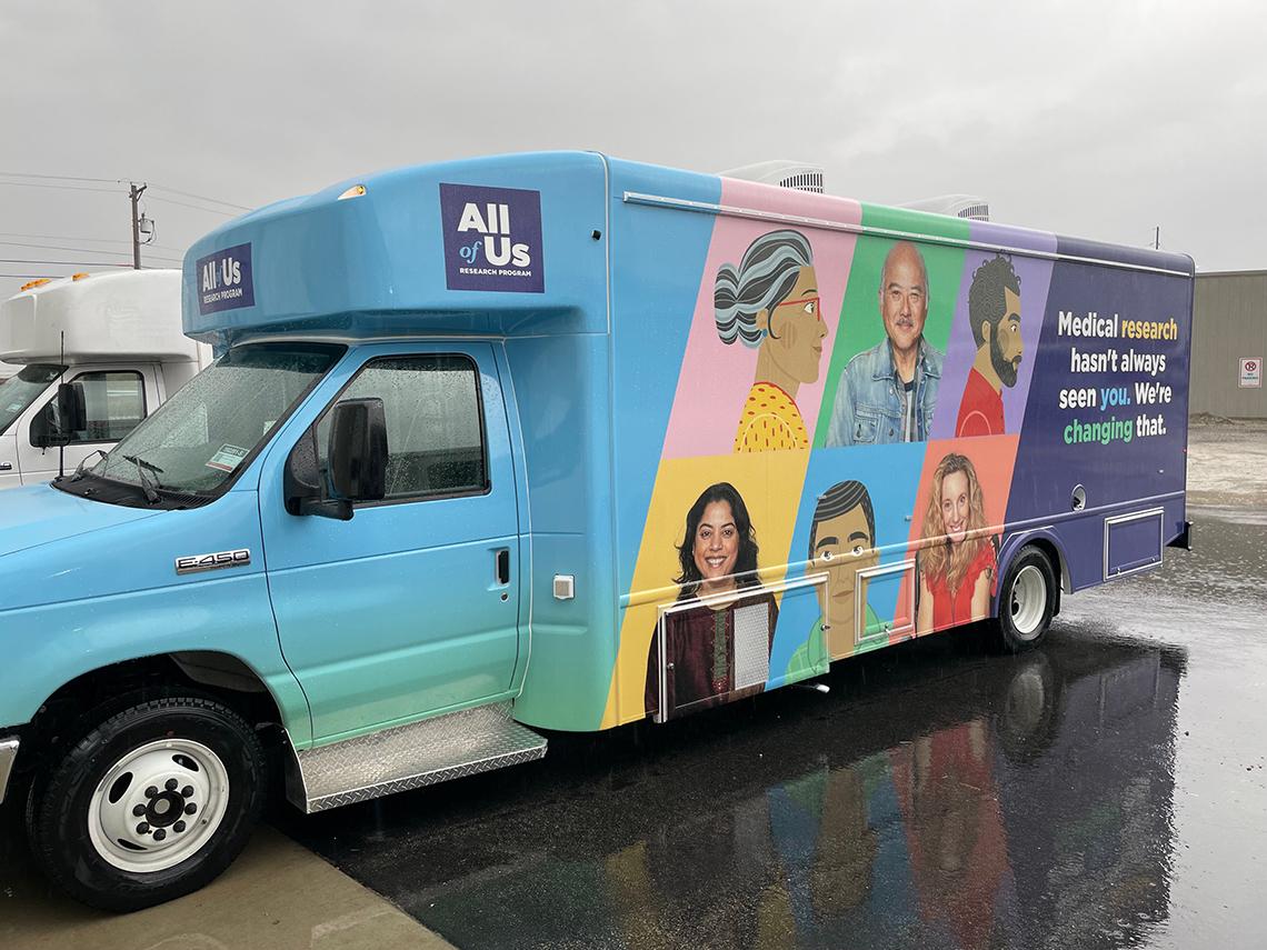 A bus featuring All of Us' logo