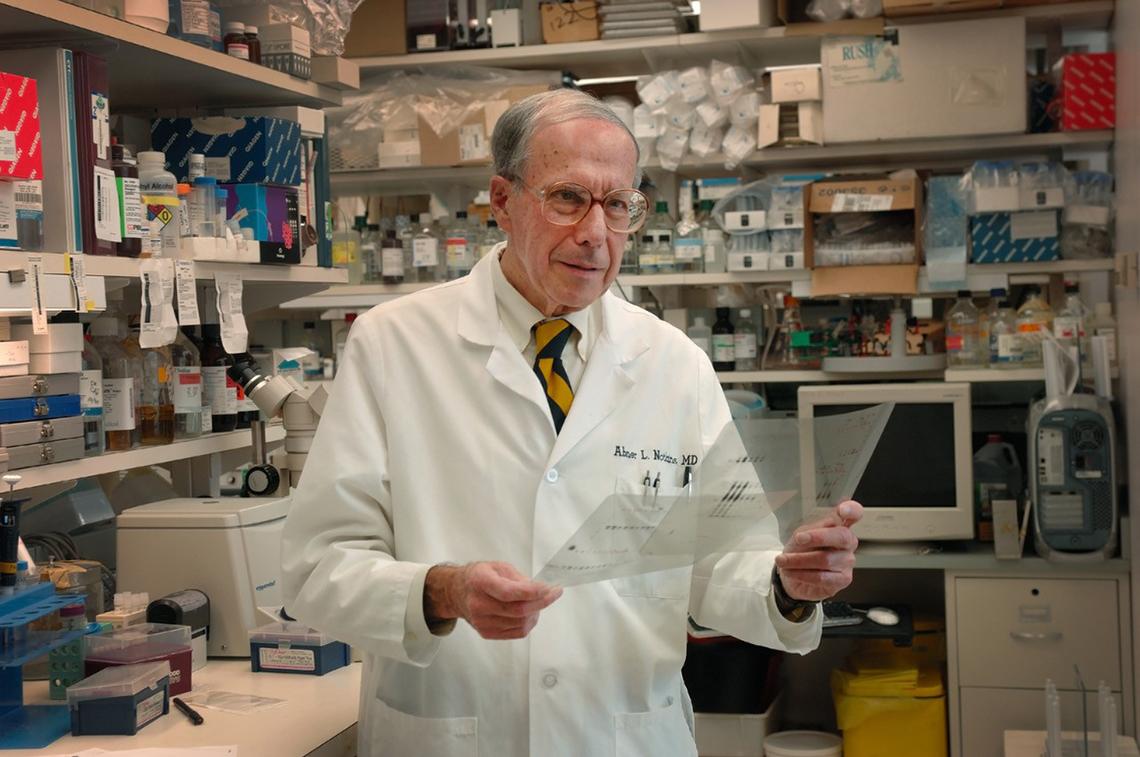 Notkins reviews files in a lab