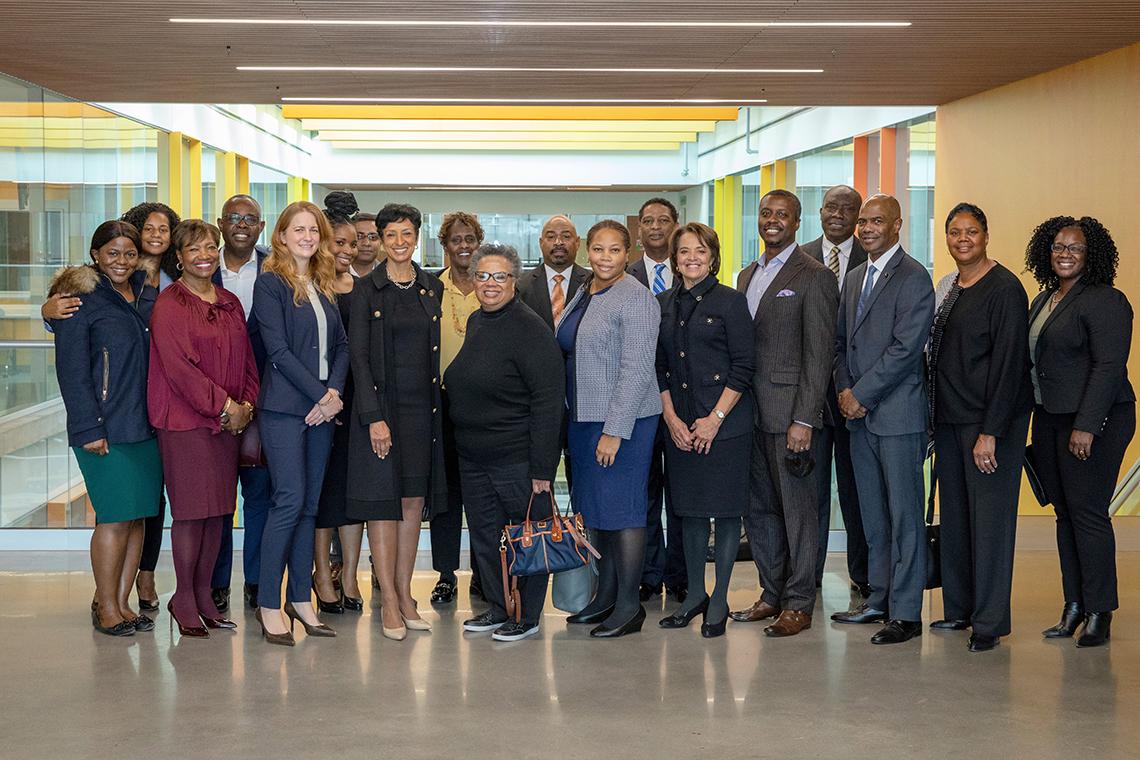 Large group of people smile into camera