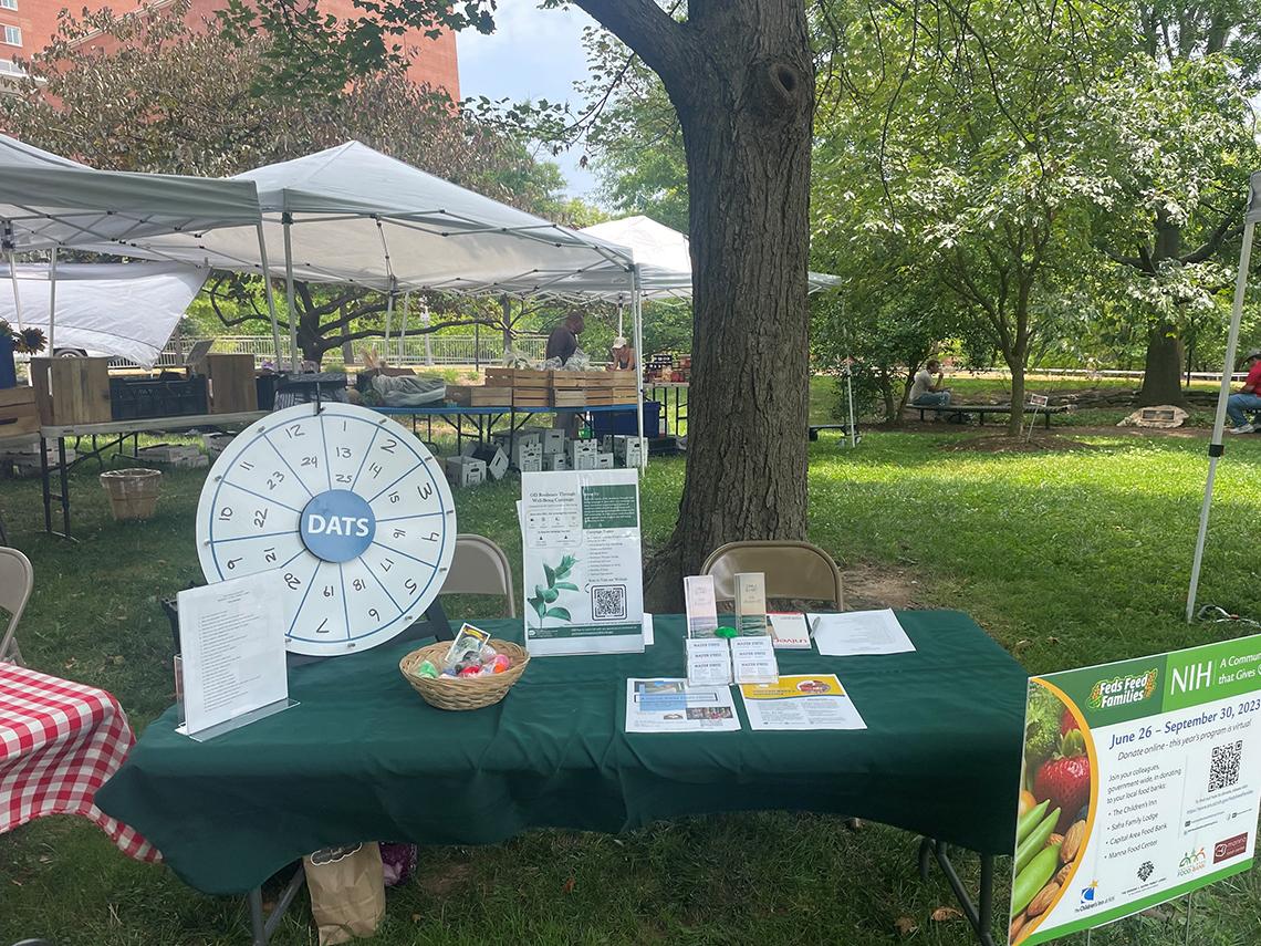 An information table with Feds Feeds Families brochures and trinkets