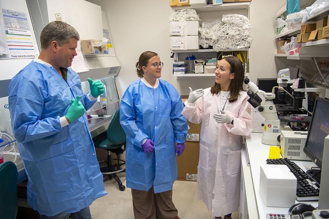 Three scientists use sign language