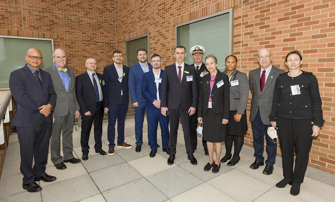 Group photo of Ukraine delegation and NIH hosts, standing on a CC terrace