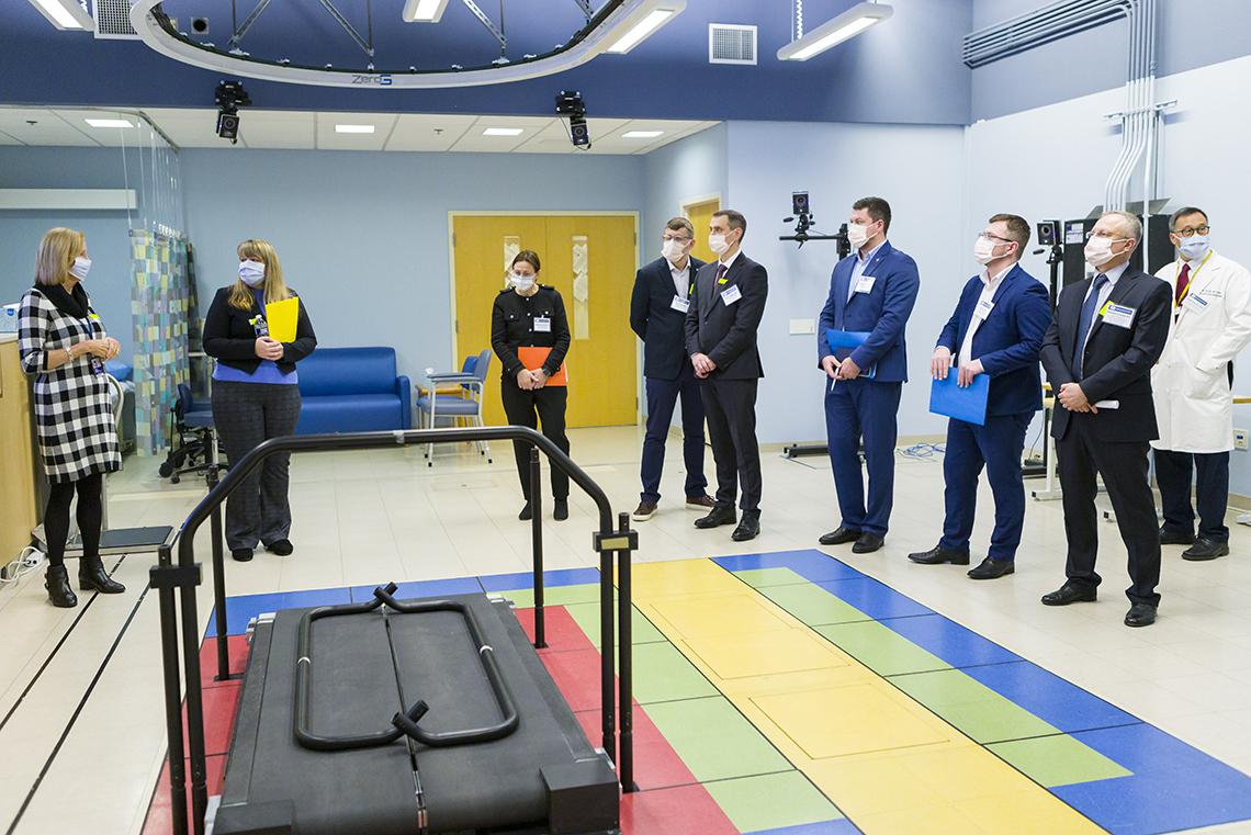 Colorful floor tiles, a treadmill and other equipment in the rehab lab