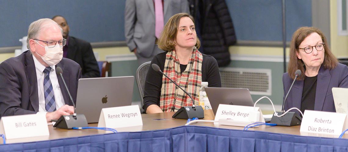 Seated at a conference table, Tabak, Wegrzyn and Berg