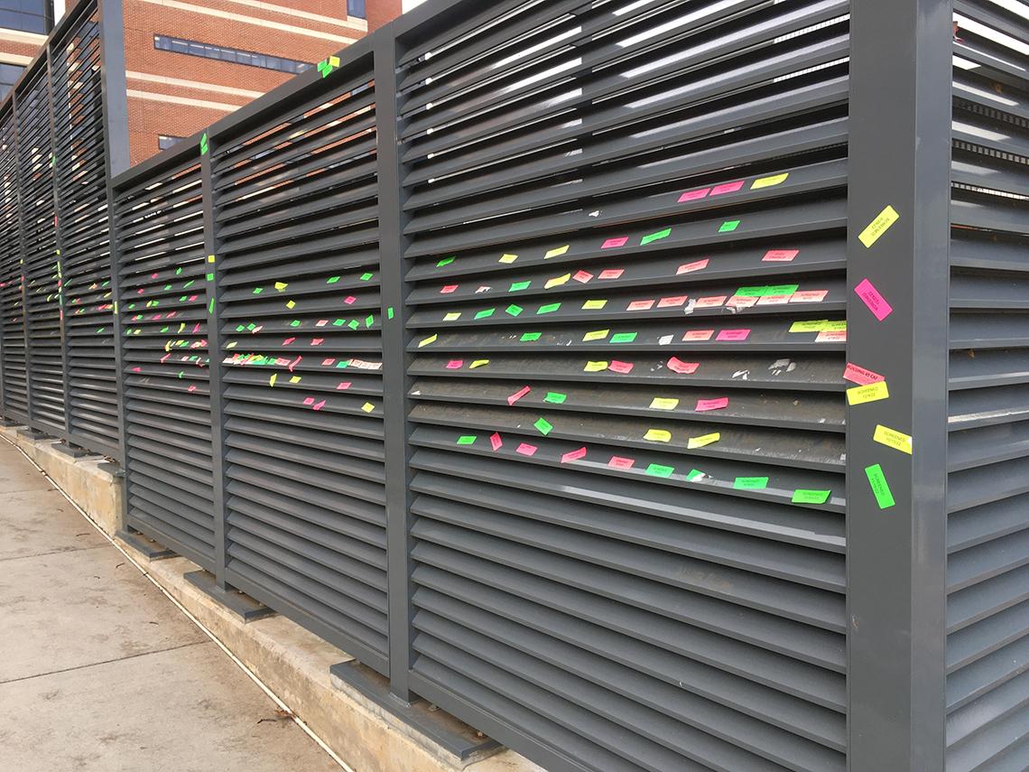 Grates near the Clinical Center are lined with colorful check-in stickers
