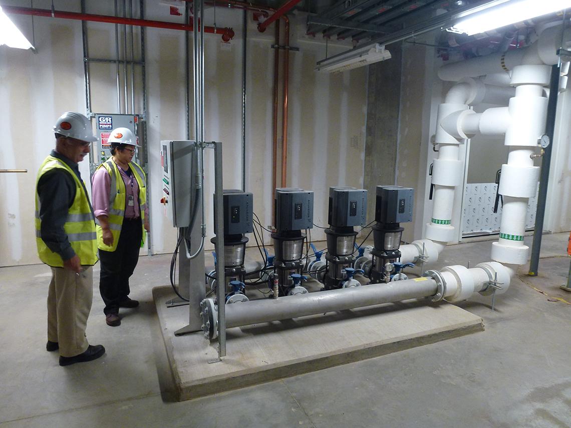 Kaolawanich and a colleague perform an inspection in a machine room