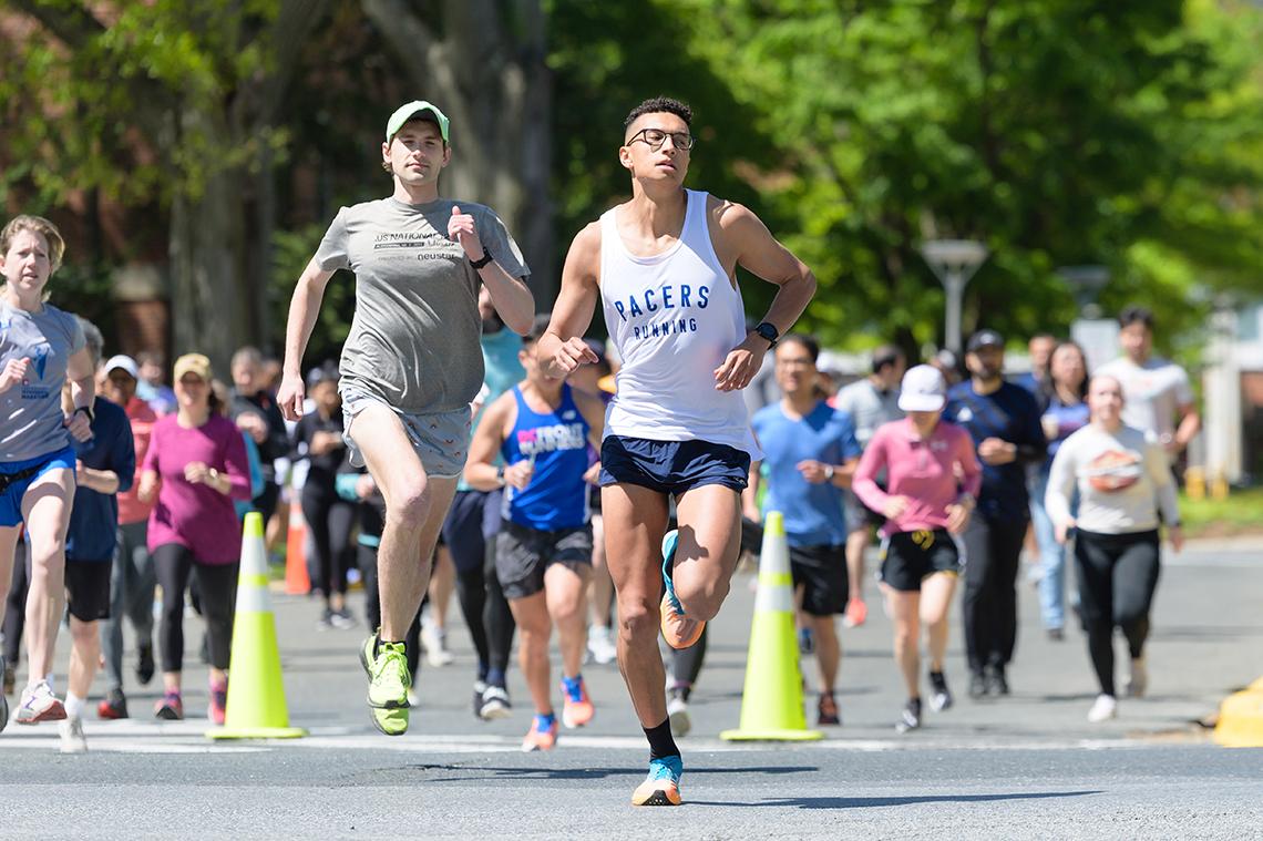 Runners navigate through yellow cones along the path.