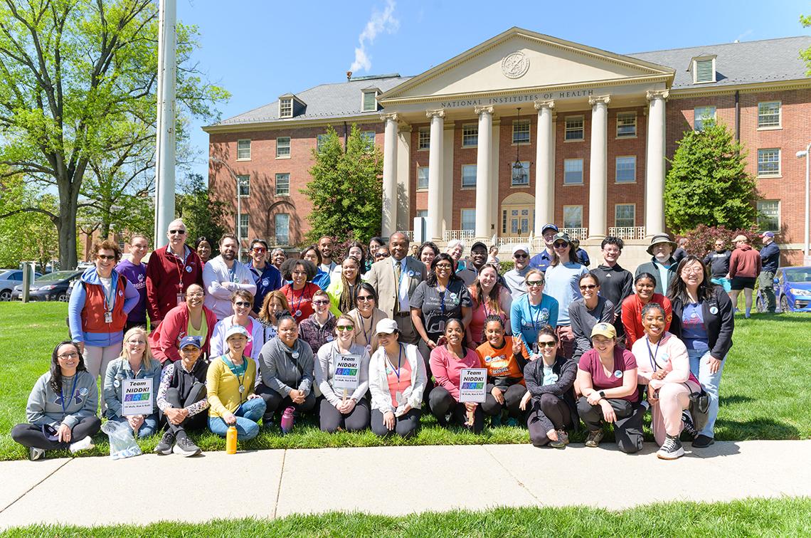 A large group from NIDDK pose outside, in front of Bldg. 1