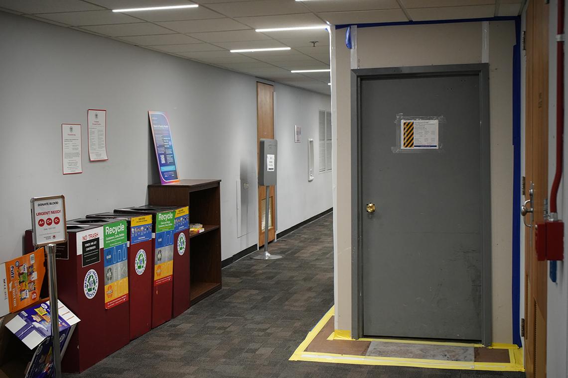 Hallway with bathroom door closed off 