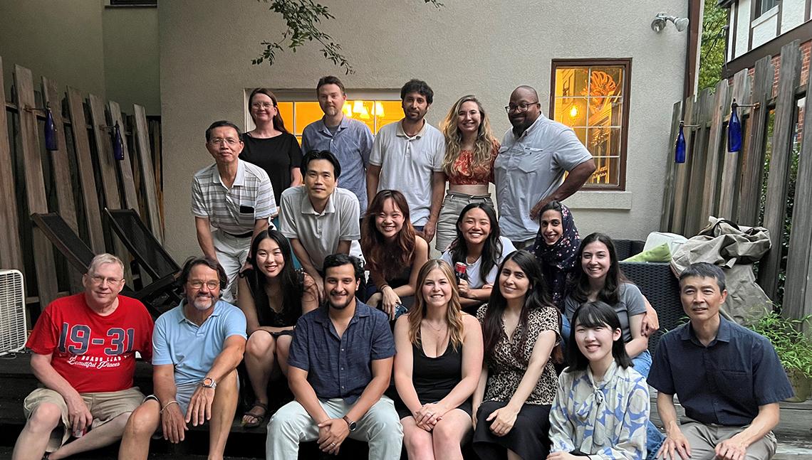 Several rows of colleagues seated in Tisdale's home