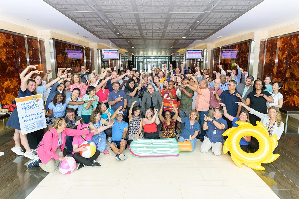 Huge group gathers seated around NCI director.