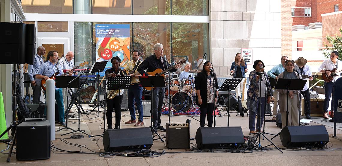 The ARRA band performs outdoors, in the shade in front of the CC south entrance.