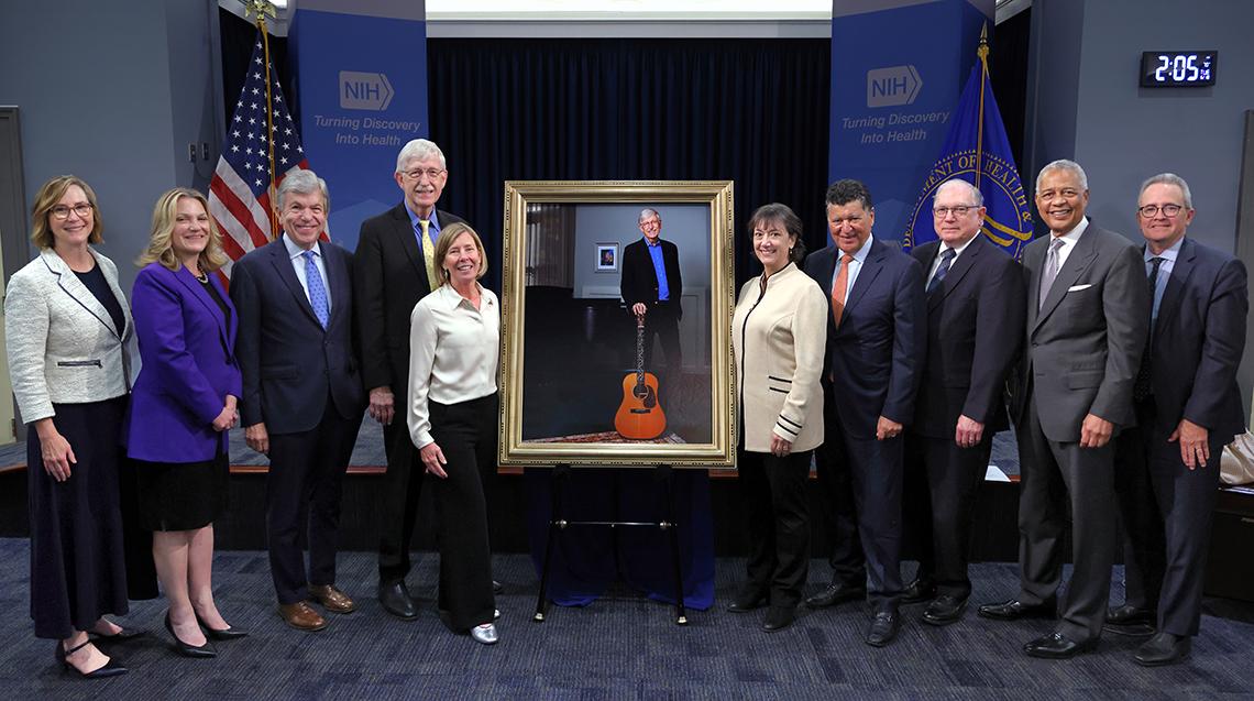 All of the speakers pose together with Collins and the official portrait.