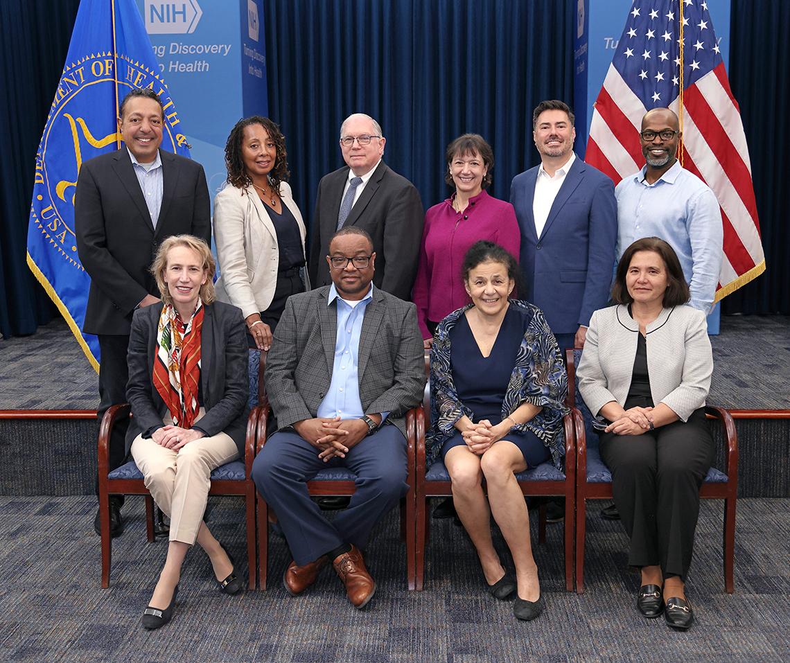 large group photo with U.S. and PHS flags behind them on either side