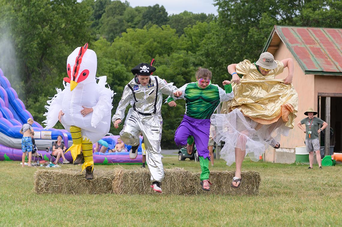 Four participants take part in a costume race