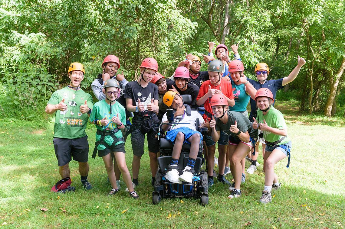 The Teen Challenge Class celebrates after completion of the course. They are wearing hard hats.