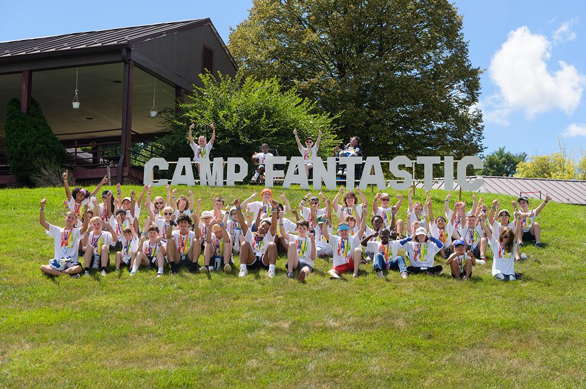 Group photo featuring campers in front a Camp Fantastic sign