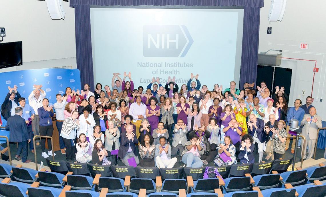 Attendees make the butterfly sign, denoting lupus.