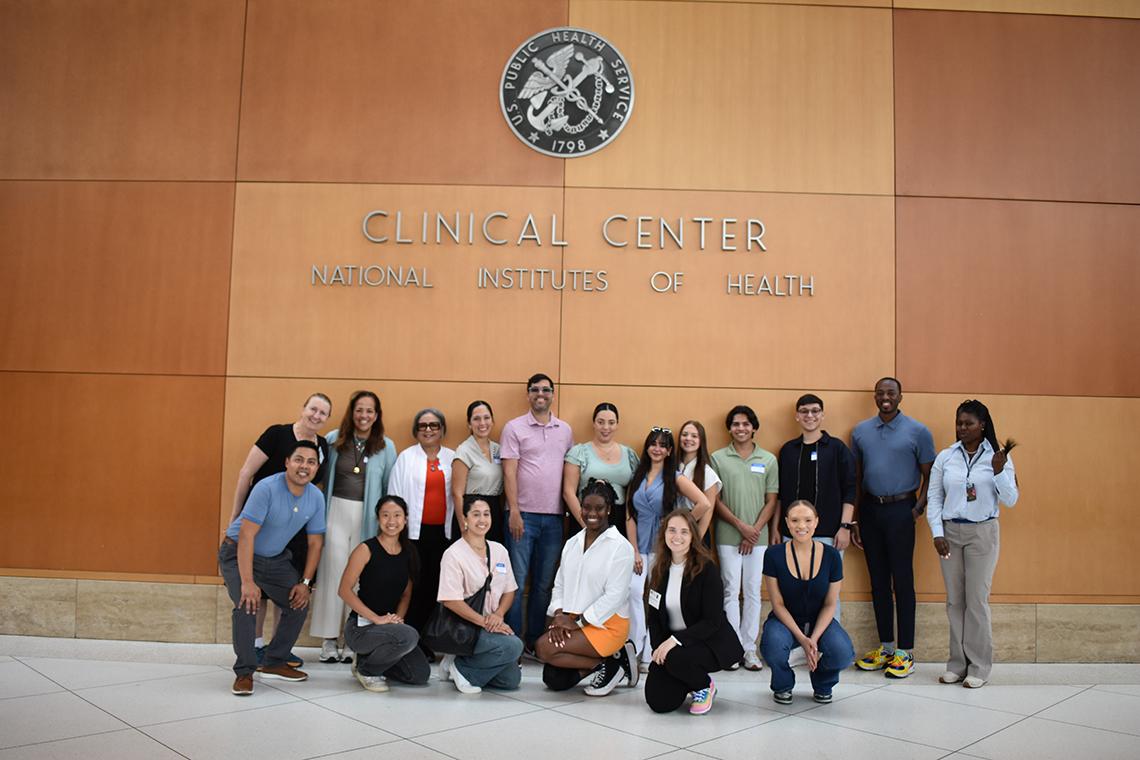 The students pose for a group photo in the lobby of the Clinical Center.