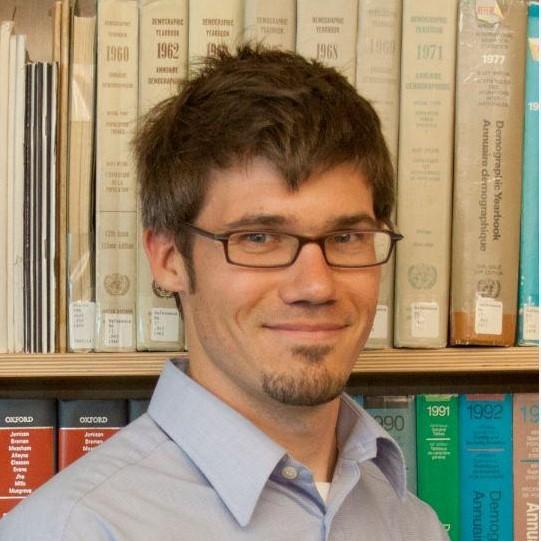 Dr. Joseph Dieleman in front of bookcase