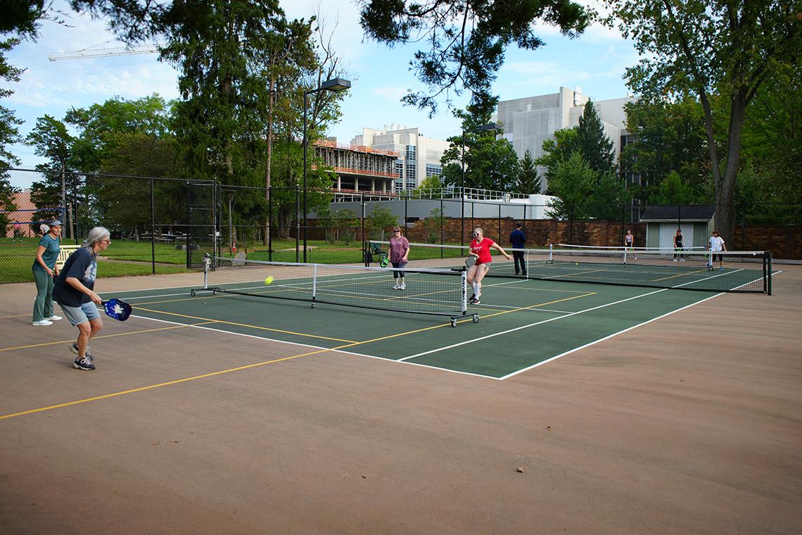 Four club members play pickleball