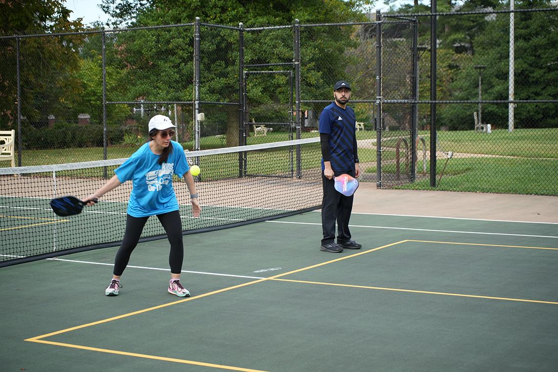 Pickleballers play on the court