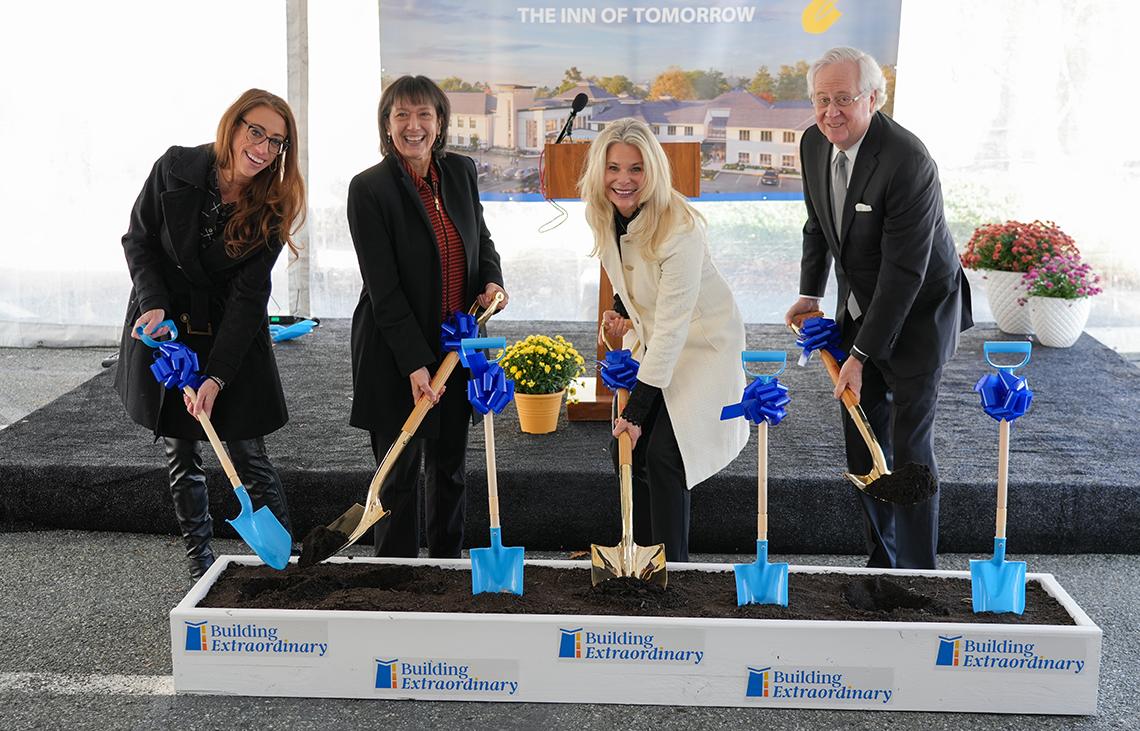 The ceremony's speakers hold shovels and break ground 