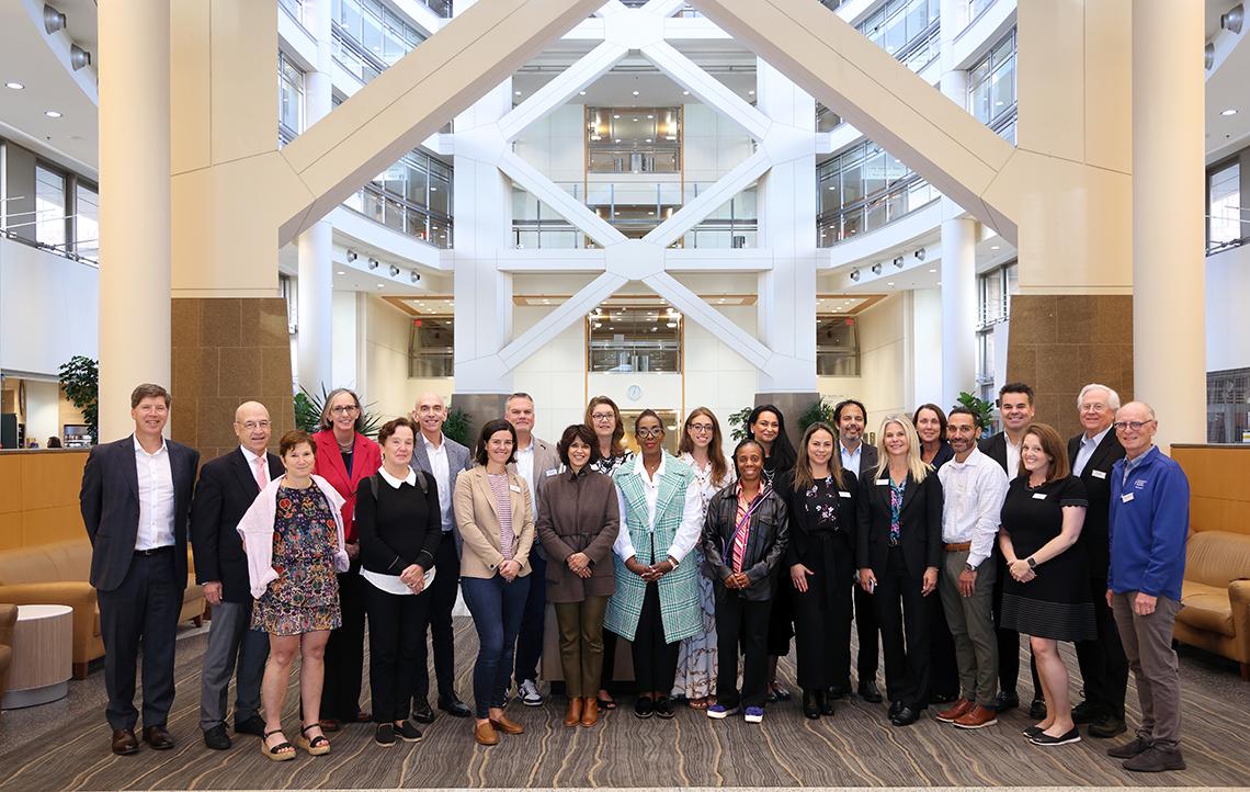 A large group poses in Clinical Center atrium.