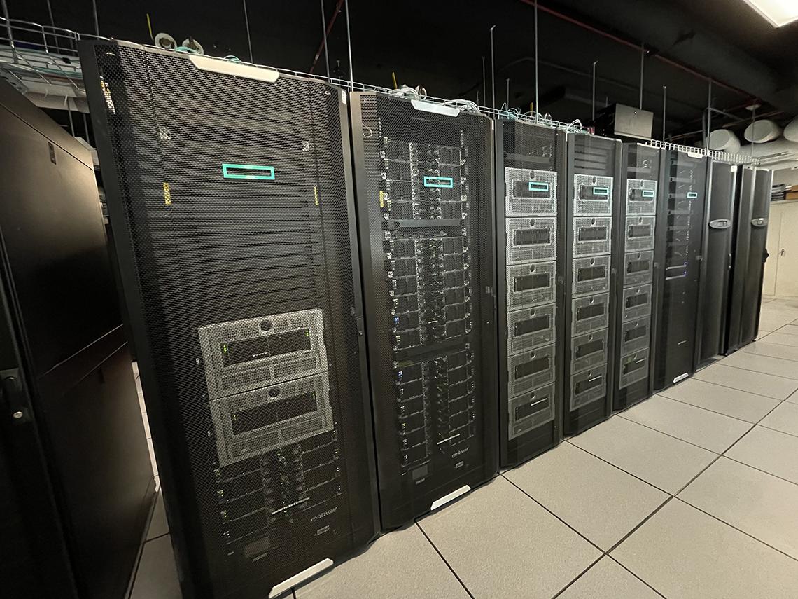 A row of black towers containing silver and black computing equipment.