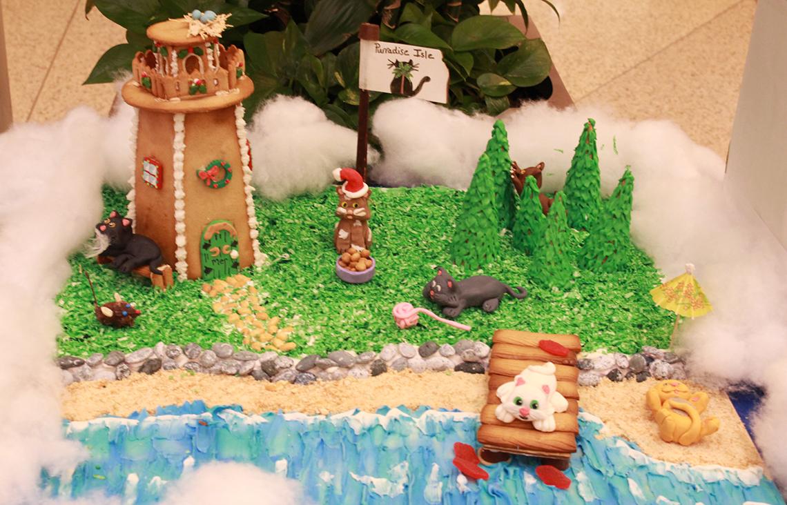 gingerbread lighthouse with animals relaxing on a beach