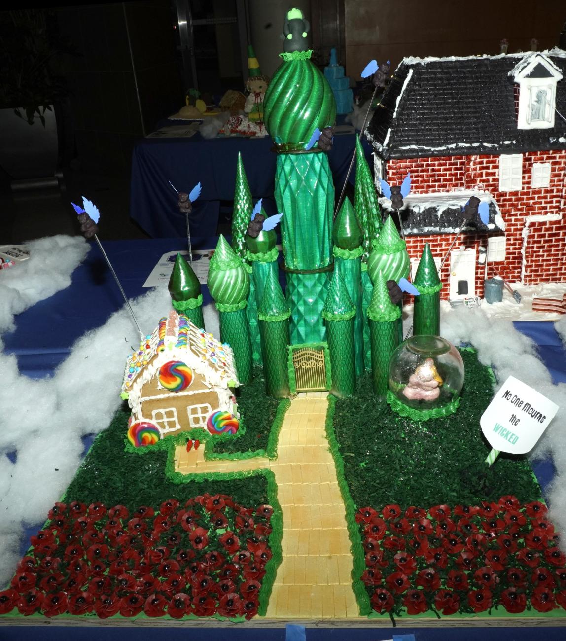 The Emerald City gingerbread: a large green castle with yellow brick road and poppies on either side