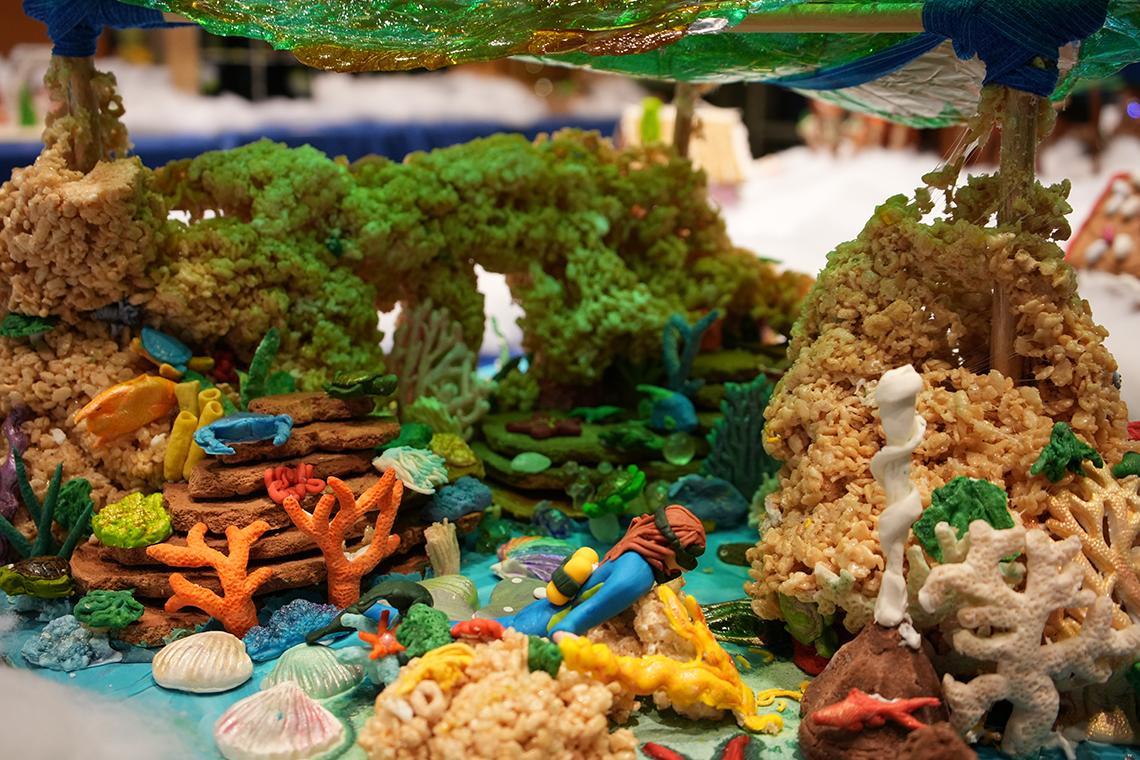 A gingerbread and candy underwater scene: the ocean floor with shells, crabs, an eel and other sea creatures with candy and Rice Krispie treats as coral
