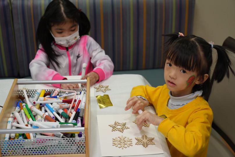 Two girls decorate arts and crafts