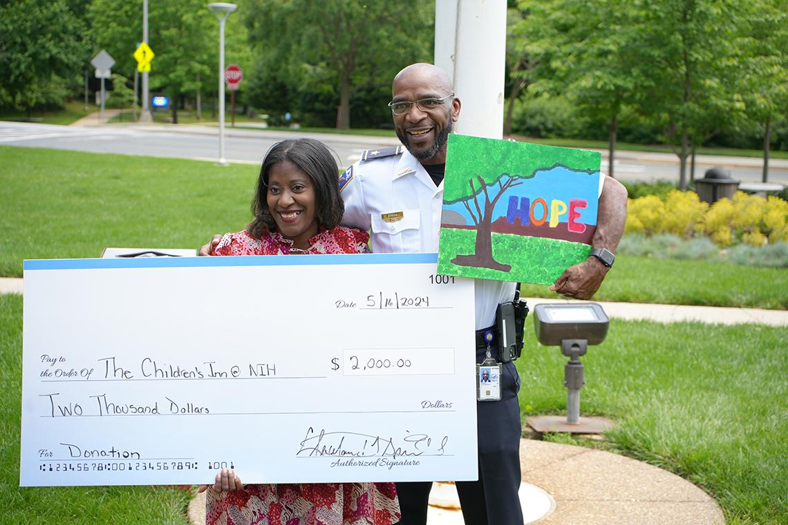 Spruill and Campbell with a large check