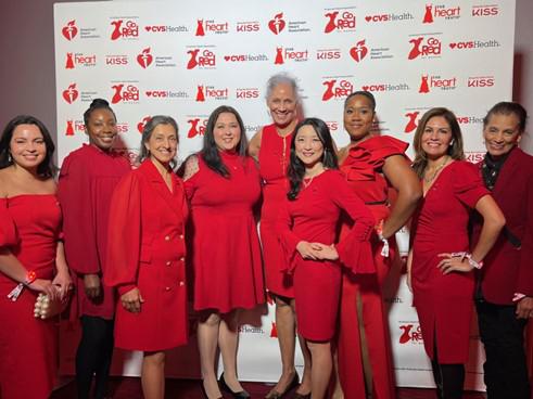 A group of women in red outfits pose for a photo
