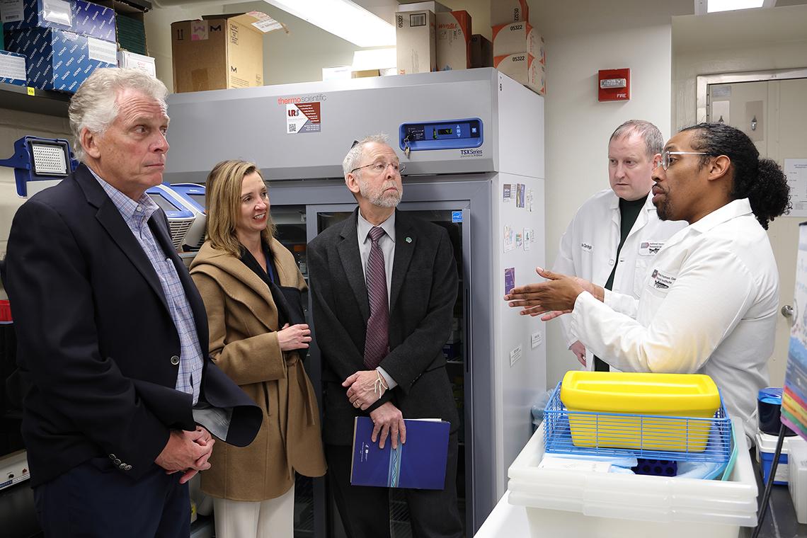 McAuliffe, Kapustij, Dr. Green, Carrington and Bishop talk in a lab