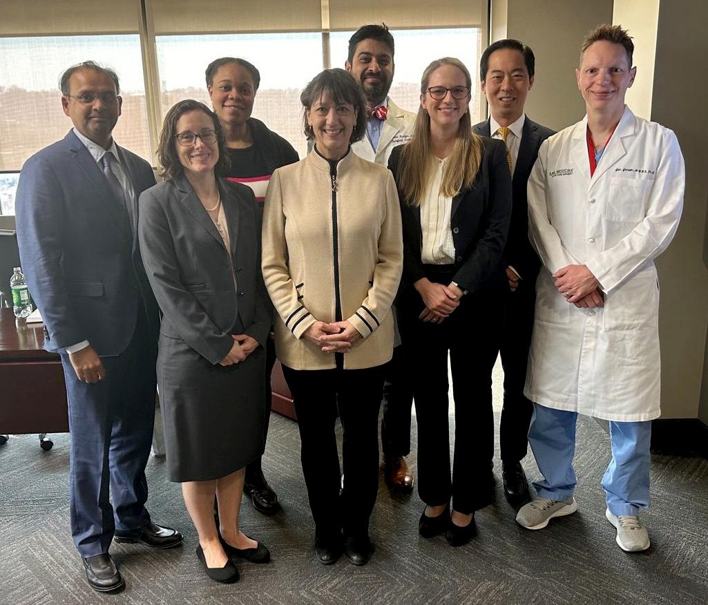 Bertagnolli stands in center of group.