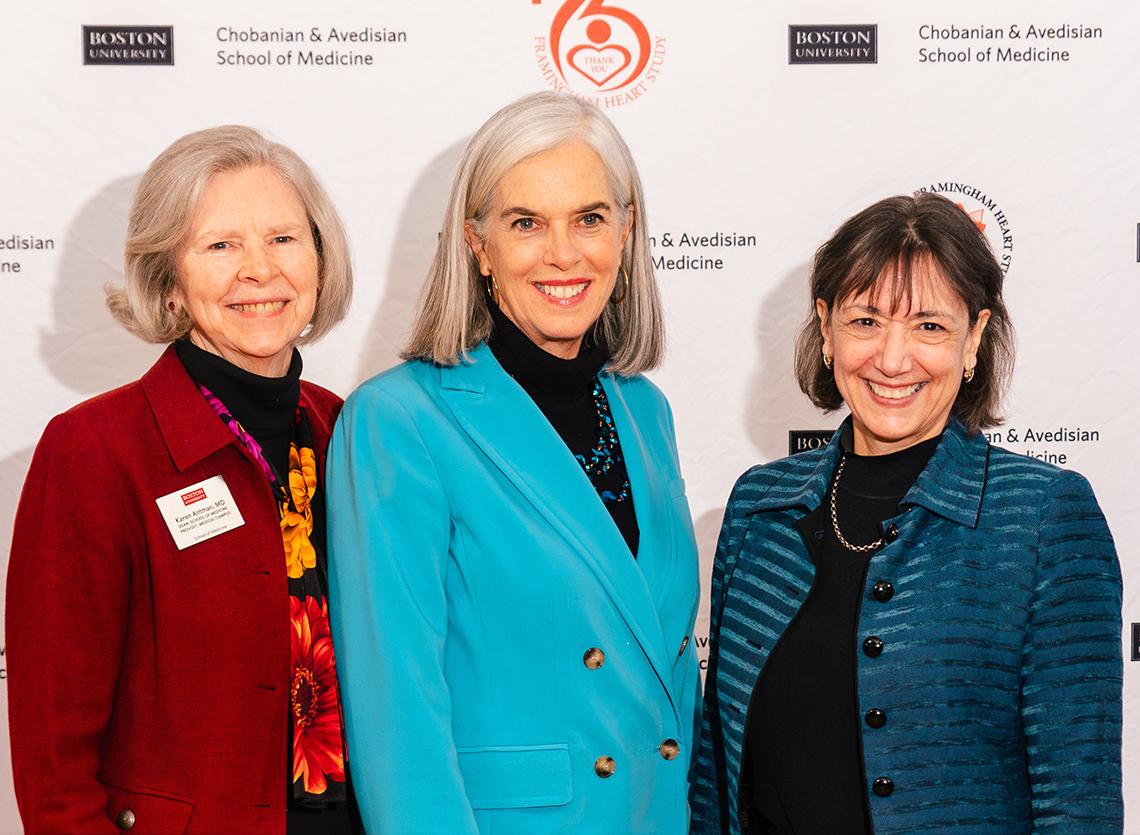 Antman, Rep. Clark and Dr. Bertagnolli pose together, smiling, in front of Boston University backdrop.