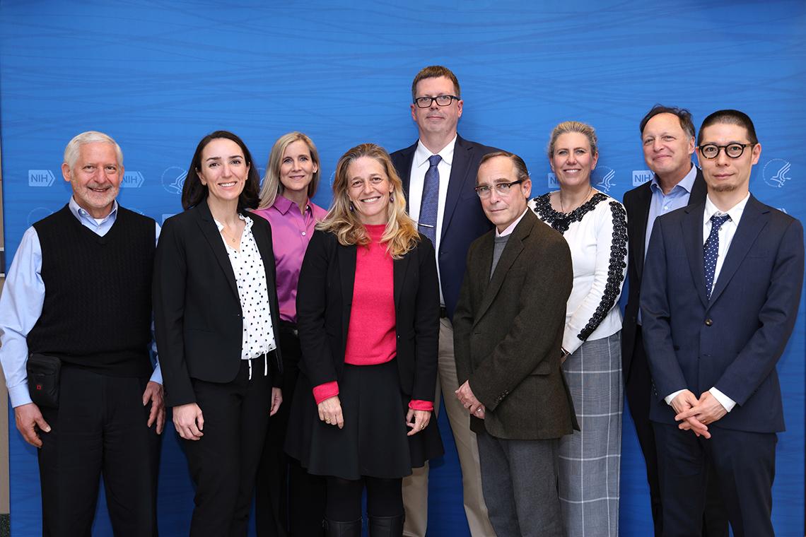 Alroy-Preis and VRC staff pose for a photo against a blue backdrop.
