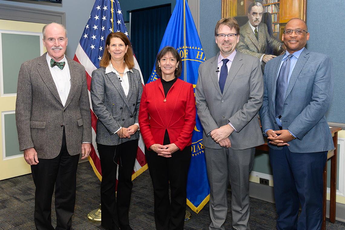 Neuzil and Mooney pose with NIH leaders in Wilson Hall.