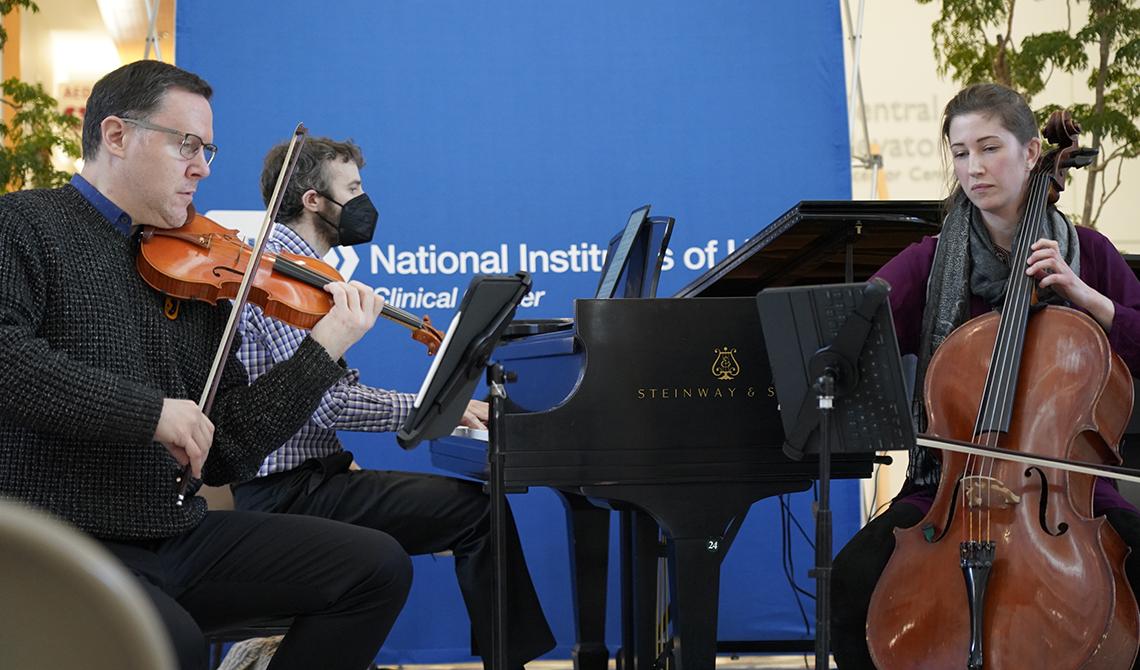 Trio on violin, piano, cello in the atrium