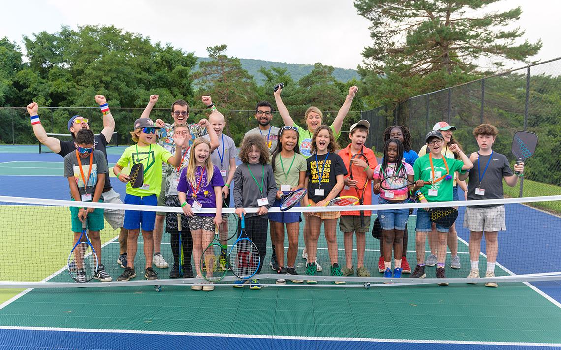 Group photo of kids on pickleball court