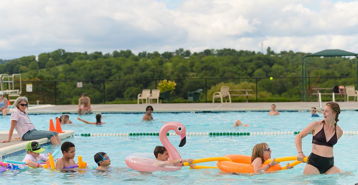 Children on floaties in a swimming pool