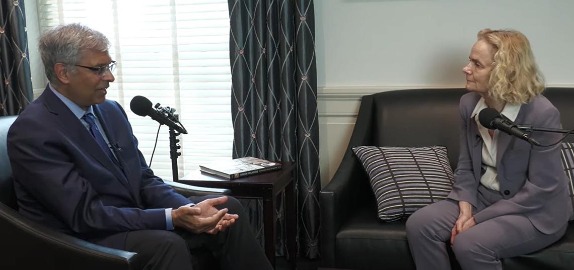 Bhattacharya and Dr. Nora Volkow seated, facing each other